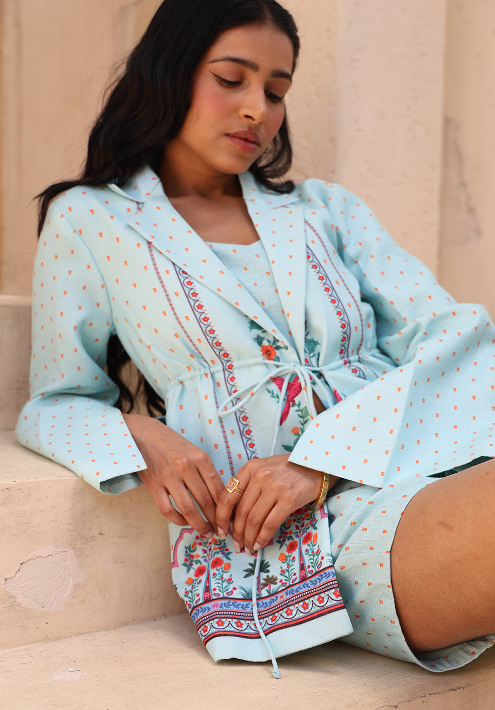 Seated lifestyle shot of Birdsong blazer coord set