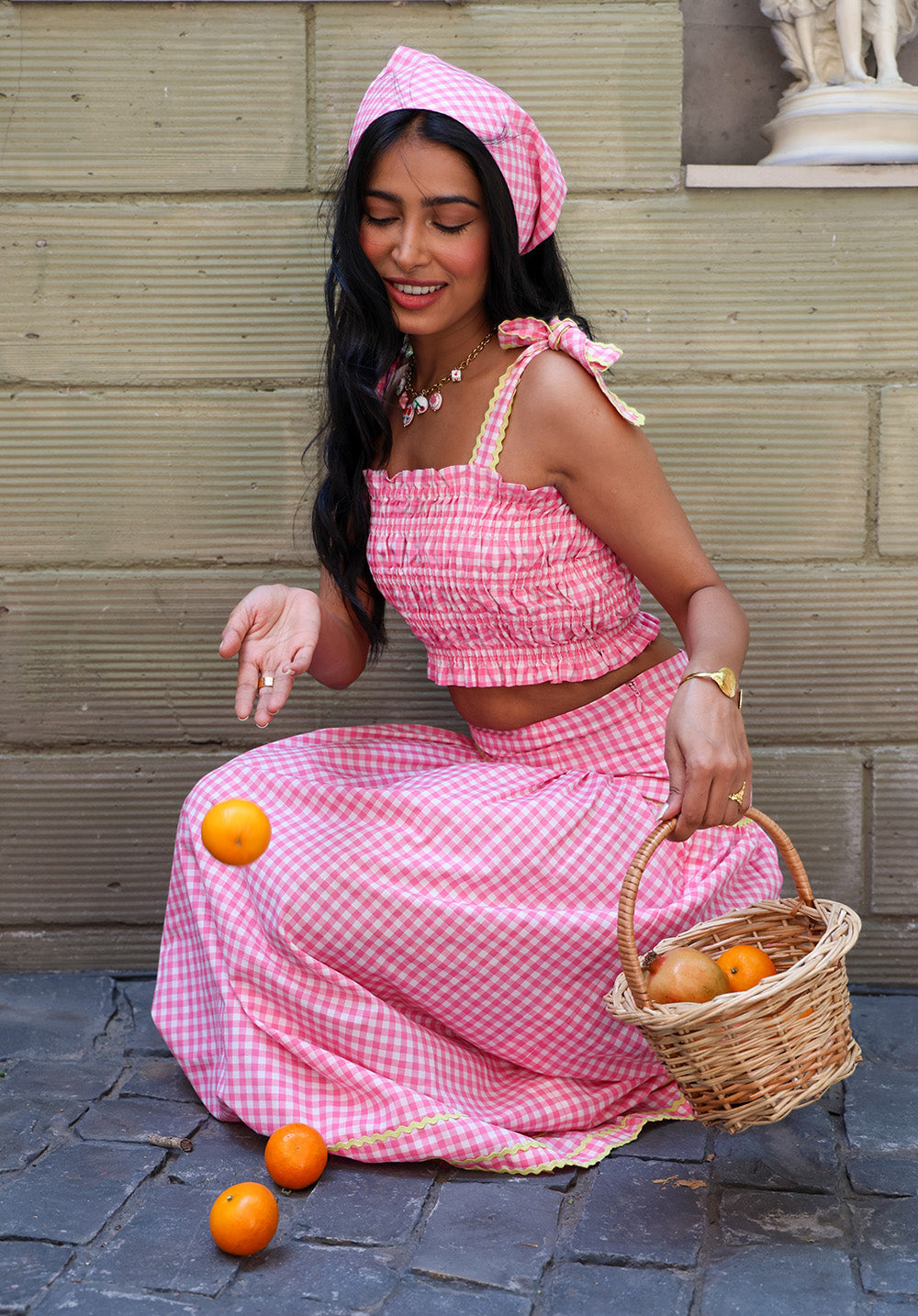 Lifestyle shot of model wearing Blush Crush gingham coord set with basket