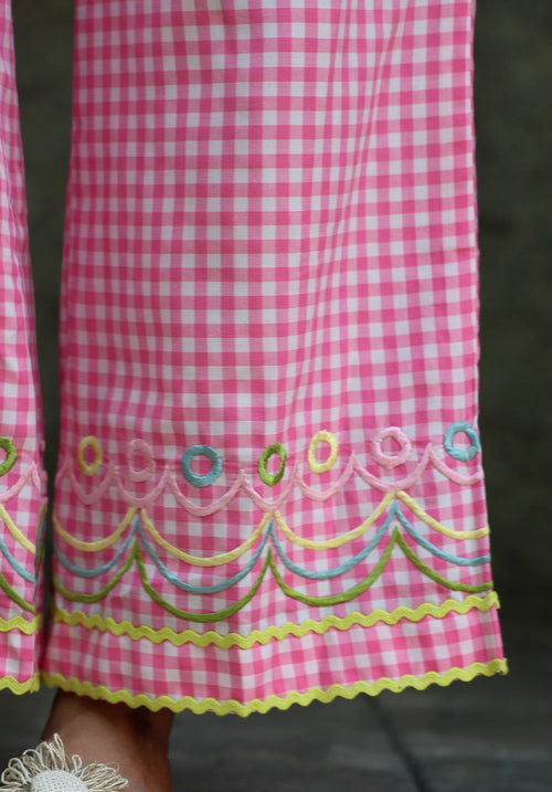 Close-up of embroidered hem detail on Blush Crush pants