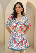 Model wearing June floral printed mini dress with puff sleeves and belt