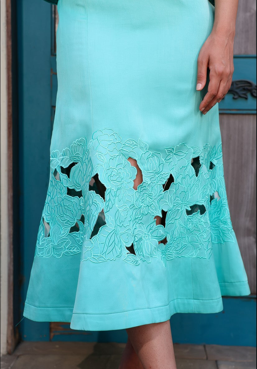 Modern summer coord set in aqua blue with airy pleated detailing and statement floral embroidery near the hem.
