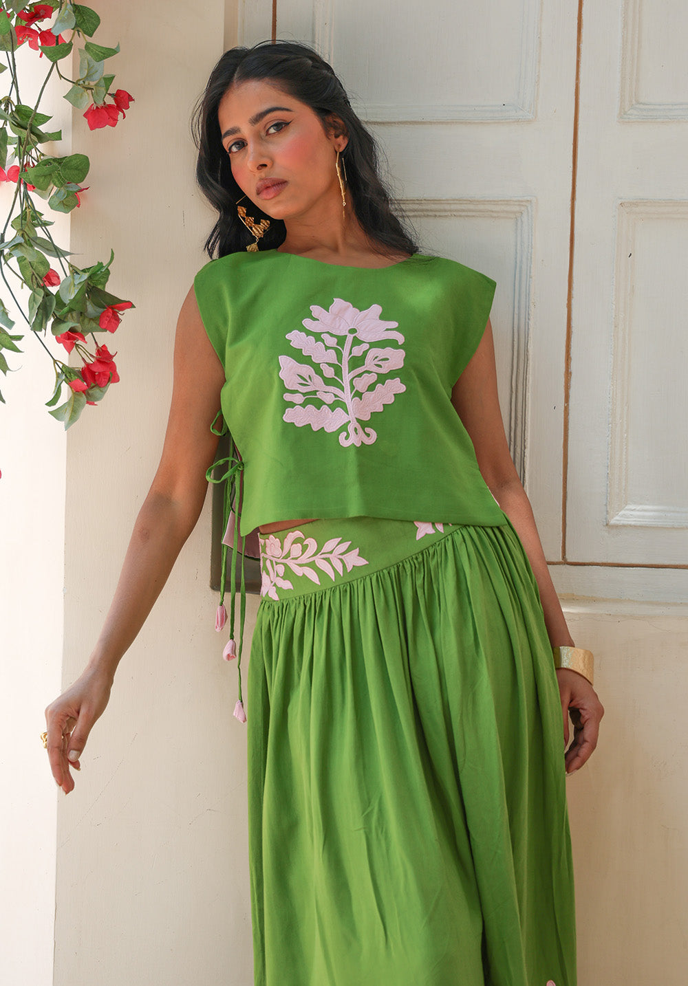 Close-up view of the Olive Bloom coord set highlighting blush floral appliqué, gathered drape, and handcrafted detailing.