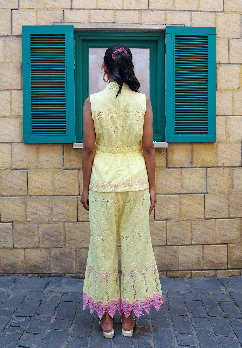 Back view of pastel yellow embroidered coord set with sleeveless tailored waistcoat and pants