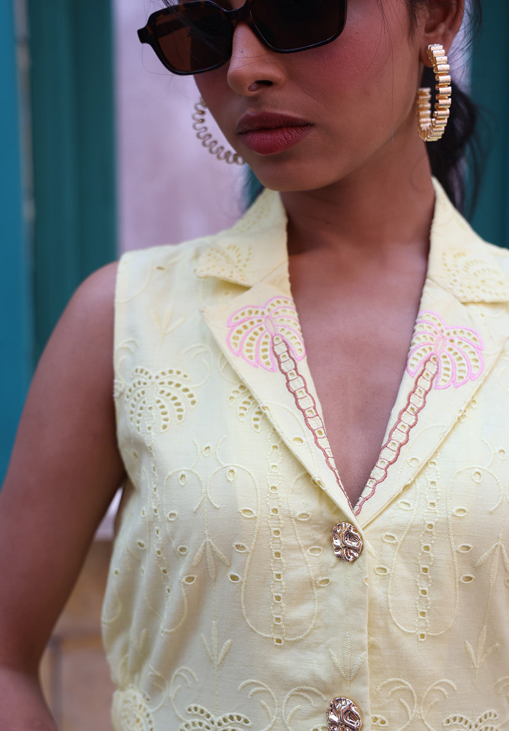 Front close-up of pastel yellow embroidered waistcoat with tailored silhouette and palm motifs