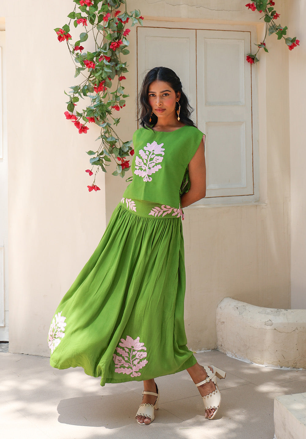 Olive Bloom coord set captured in motion with a flowing green skirt and delicate floral detailing from Arcadian Dream SS’26.