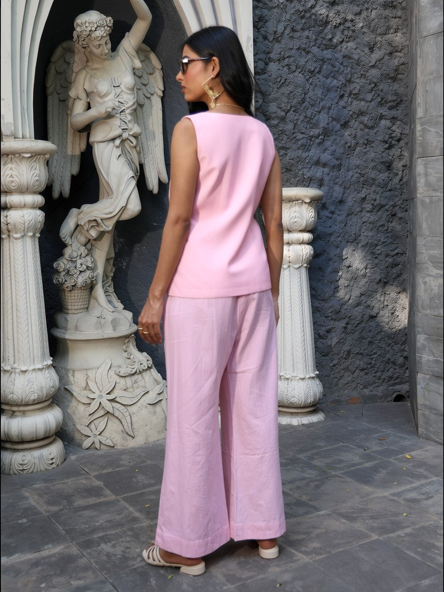 Back view of blush pink coord set featuring sleeveless top and wide-leg pants.